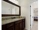 Bathroom with dark wood cabinetry, granite countertop, and large mirror at 2875 Waterstone Dr, Cumming, GA 30041