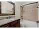Bathroom with granite vanity, decorative mirror, and tub/shower combo with tile surround at 2875 Waterstone Dr, Cumming, GA 30041