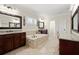 Primary bathroom with a soaking tub, granite countertops, and sinks and ample counterspace at 2875 Waterstone Dr, Cumming, GA 30041