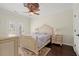 Charming bedroom featuring a ceiling fan, neutral walls, and beautiful hardwood floors at 2875 Waterstone Dr, Cumming, GA 30041