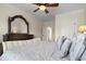 Comfortable bedroom featuring a large decorative mirror over an antique dresser with soft, neutral tones at 2875 Waterstone Dr, Cumming, GA 30041