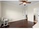 Bright bedroom featuring hardwood floors, ceiling fan, and neutral paint colors at 2875 Waterstone Dr, Cumming, GA 30041