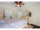 Inviting bedroom featuring a ceiling fan, neutral walls, and beautiful hardwood floors at 2875 Waterstone Dr, Cumming, GA 30041