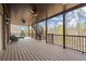 Covered back deck with ceiling fans, stairs to yard, and wooded views for peaceful outdoor living at 2875 Waterstone Dr, Cumming, GA 30041