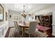 Elegant dining room with wainscoting, chandelier, and a view into another room at 2875 Waterstone Dr, Cumming, GA 30041