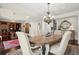 Well-lit dining room with a large table, decorative chandelier, and access to other living spaces at 2875 Waterstone Dr, Cumming, GA 30041