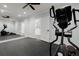 Spacious home gym featuring rubber flooring, a full-length mirror, elliptical machine, and ceiling fan at 2875 Waterstone Dr, Cumming, GA 30041