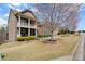 Beautiful brick home with a covered porch, lush green lawn, and attractive landscaping at 2875 Waterstone Dr, Cumming, GA 30041