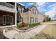 Traditional brick home with a manicured lawn, landscaped garden beds, and a welcoming entrance at 2875 Waterstone Dr, Cumming, GA 30041