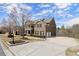 Inviting brick home boasts a spacious driveway, manicured lawn, and a classic architectural design at 2875 Waterstone Dr, Cumming, GA 30041