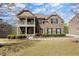 Charming brick home featuring a covered porch, well-manicured landscaping, and inviting curb appeal at 2875 Waterstone Dr, Cumming, GA 30041