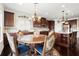 This kitchen features dark wood cabinets, stainless steel appliances, granite countertops, and an island with seating at 2875 Waterstone Dr, Cumming, GA 30041