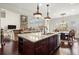 Open concept kitchen features granite countertops, a center island with seating, and stainless steel appliances at 2875 Waterstone Dr, Cumming, GA 30041
