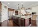 Kitchen with granite countertops, stainless steel appliances, dark wood cabinets, and a center island at 2875 Waterstone Dr, Cumming, GA 30041