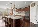 Gourmet kitchen features a large island with seating, stainless steel appliances, and dark wood cabinetry at 2875 Waterstone Dr, Cumming, GA 30041