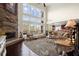 A spacious living room with stone fireplace and large windows bringing in natural light at 2875 Waterstone Dr, Cumming, GA 30041