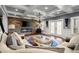 Inviting living room featuring stone fireplace, modern lighting, and hardwood floors at 2875 Waterstone Dr, Cumming, GA 30041