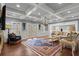 Living room with coffered ceiling, hardwood floors, elegant furnishings, and natural light at 2875 Waterstone Dr, Cumming, GA 30041