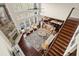 Open-concept living room with a stone fireplace, floor-to-ceiling windows, and hardwood floors offers a cozy and bright space at 2875 Waterstone Dr, Cumming, GA 30041