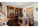 The spacious office features an elaborate built-in bookcase with ladder and decorative shelving at 2875 Waterstone Dr, Cumming, GA 30041