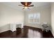 Office room featuring wood floors, a bright window with shutters, and a white desk at 2875 Waterstone Dr, Cumming, GA 30041