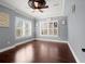 A bright playroom featuring hardwood floors, crown molding, plantation shutters, and ample natural light at 2875 Waterstone Dr, Cumming, GA 30041