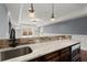 A wet bar with stone accents, granite countertops, and a stainless steel microwave, adding convenience and style at 2875 Waterstone Dr, Cumming, GA 30041