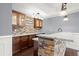 The wet bar boasts granite countertops, stone backsplash, and wooden cabinets at 2875 Waterstone Dr, Cumming, GA 30041