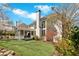 Beautiful back exterior featuring a spacious lawn, screened-in porch, and mature trees at 3509 Ivy Manor Se Rd, Smyrna, GA 30080