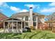 Stunning back exterior of the home with a sunroom, large windows, and a well-maintained lawn at 3509 Ivy Manor Se Rd, Smyrna, GA 30080