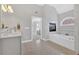 Luxurious bathroom with a soaking tub, fireplace, glass shower, and stylish gray vanity at 3509 Ivy Manor Se Rd, Smyrna, GA 30080