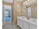 Bathroom with double sink vanity, white cabinets, and framed mirrors offering ample space and storage at 3509 Ivy Manor Se Rd, Smyrna, GA 30080
