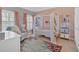 Charming bedroom featuring a canopied bed, colorful rug, and bright windows with stylish curtains at 3509 Ivy Manor Se Rd, Smyrna, GA 30080