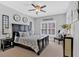 Cozy bedroom with farmhouse decor, a large bed, side tables, and shuttered windows for a relaxing ambiance at 3509 Ivy Manor Se Rd, Smyrna, GA 30080