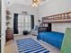 Cozy bedroom featuring a ceiling fan and a wooden bunk bed with a blue striped blanket at 3509 Ivy Manor Se Rd, Smyrna, GA 30080