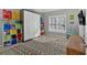 Bright bedroom featuring natural light, colorful storage shelves, and eye-catching abstract art at 3509 Ivy Manor Se Rd, Smyrna, GA 30080