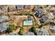 Aerial view of a community pool area, featuring a pool house, mature trees, landscaping, and parking at 3509 Ivy Manor Se Rd, Smyrna, GA 30080