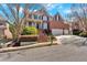 Two-story brick home with a three-car garage, landscaped front yard, and a staircase leading to a columned front porch at 3509 Ivy Manor Se Rd, Smyrna, GA 30080