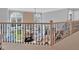 Open foyer with grand staircase and wrought iron railing overlooking a bright living room with fireplace at 3509 Ivy Manor Se Rd, Smyrna, GA 30080