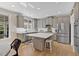 Open concept kitchen features modern cabinets, stainless appliances, and a kitchen island with seating at 3509 Ivy Manor Se Rd, Smyrna, GA 30080