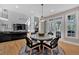 Open-concept living room with hardwood floors, fireplace, and natural light, connecting to dining area at 3509 Ivy Manor Se Rd, Smyrna, GA 30080