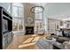 Bright living room with large windows, hardwood floors, a fireplace, and an open layout to dining area at 3509 Ivy Manor Se Rd, Smyrna, GA 30080