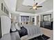 Elegant main bedroom with tray ceiling, black accents, and a bright sitting area at 3509 Ivy Manor Se Rd, Smyrna, GA 30080