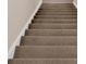 Carpeted staircase leading to the upper level, showcasing the home's functional design and comfortable living spaces at 3509 Ivy Manor Se Rd, Smyrna, GA 30080