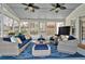 Bright sunroom with cozy seating, ceiling fans, and views of the landscaped backyard at 3509 Ivy Manor Se Rd, Smyrna, GA 30080