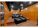 Home theater with tiered seating, wood paneling, and projector screen at 3509 Ivy Manor Se Rd, Smyrna, GA 30080