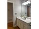 Bathroom with vanity, granite counters, decorative accents, and a large mirror at 4748 Arcado Sw Rd, Lilburn, GA 30047