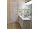 Bright bathroom featuring a granite countertop, a modern sink, and white cabinets at 4748 Arcado Sw Rd, Lilburn, GA 30047