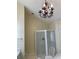 Bathroom features a chandelier and shower with clear glass door at 4748 Arcado Sw Rd, Lilburn, GA 30047