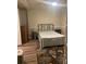 Cozy bedroom with wood-look floors, neutral walls, and a comfortable bed with a patterned rug at 4748 Arcado Sw Rd, Lilburn, GA 30047